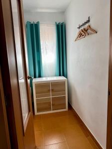 a small room with a window and a curtain at Centro Kennedy in Algeciras