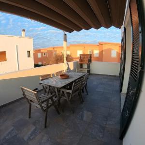 a patio with a table and chairs on a balcony at Villa Tord Massot 11 in Ciutadella