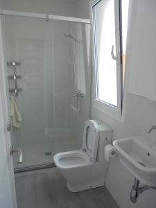 a bathroom with a toilet and a sink and a shower at Villa Tord Massot 11 in Ciutadella +13 photos