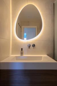a bathroom with a sink and a mirror at Le Clos de Vallaurias in Vallauris +7 photos