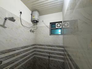 a shower in a bathroom with a window at Hotel Laxmi Palace in Khātu +36 photos