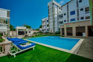 a swimming pool in the yard of a apartment building at Diani Dream stays in Diani Beach