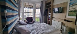a small bedroom with a bed and a window at Marine View in Brighton & Hove