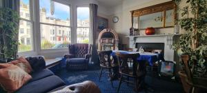 a living room with a couch and a table and a fireplace at Marine View in Brighton & Hove