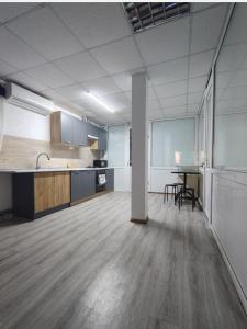 an empty room with a kitchen and a table at Ліза in Irpin