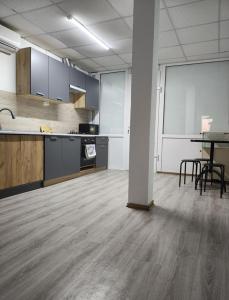 an empty room with a kitchen and a table at Ліза in Irpin