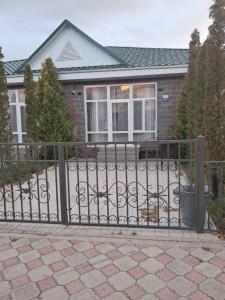 a gate in front of a house at Royal Beach Cottage Issyk Kul in Chok-Tal