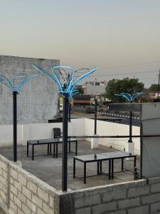 a group of benches with blue lights on them at hotel apni haveli in Mandsaur