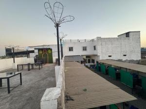 a building with a wooden boardwalk in a parking lot at hotel apni haveli in Mandsaur