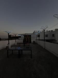 a parking lot with a table in front of a building at hotel apni haveli in Mandsaur
