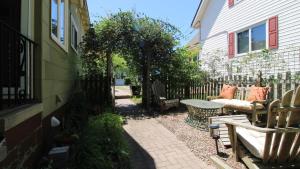 a patio with a bench and a table next to a house at Cottage On Cambridge in Cape May Point