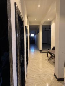 a hallway leading to a living room with a table at hotel apni haveli in Mandsaur