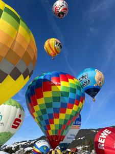a bunch of colorful hot air balloons in the sky at Haus Lorang in Pfronten