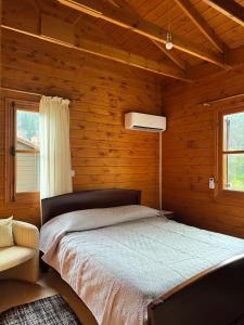 a bedroom with a bed in a wooden cabin at Η σπηλιά του Θουκυδίδη in Spilia