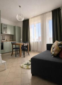 a living room with a couch and a table at Casa aMare in Chioggia