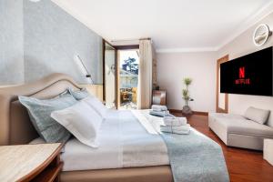 a bedroom with a large bed and a couch at Le Rose Suites - Misano World Circuit & Beach in Misano Adriatico +69 photos