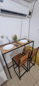 a table with two chairs and two plates on it at Ypane Residencial in Ypane