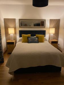 a bedroom with a large bed with two lamps at The Well Bed & Breakfast in Clonakilty
