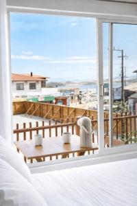 a bedroom with a bed and a view of a balcony at Pousada Surf na Guarda in Guarda do Embaú
