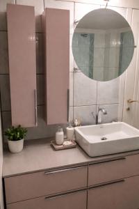 a bathroom with a sink and a mirror at A&S Luxury Apartment in Kavála +15 photos