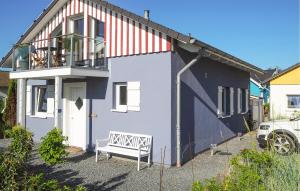 a white house with a bench in front of it at Seebrise B in Süssau