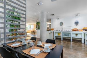 a dining room with a table and a kitchen at Cascais Hotel in Cascais