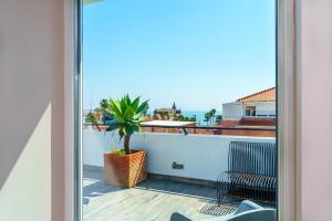 a view from a window of a balcony with a plant at Cascais Hotel in Cascais