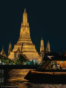 a large building is lit up at night at Swing By in Bangkok