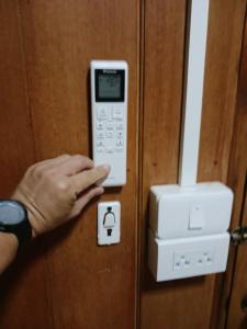 a person is unlocking a door with a cell phone at Chompor villa farmstay in Chiang Dao