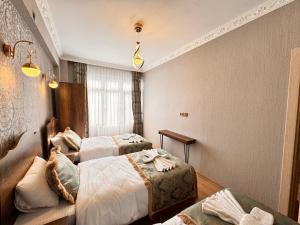 a hotel room with two beds and a couch at Nasip House in Istanbul