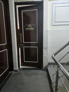 a door with a sign on it in a building at Gitanjali luxury in New Delhi +1 photo