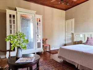 a bedroom with a bed and a table and a window at Maison Poche in Caupenne-dʼArmagnac