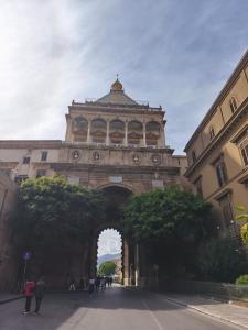 a building with an archway in the middle of a street at Lolli Station House in Palermo