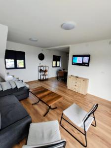 a living room with a couch and a table at Villa Kally Fruska Gora in Velika Remeta