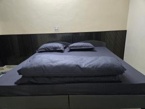a bed with blue blankets and pillows on it at Gitanjali luxury in New Delhi