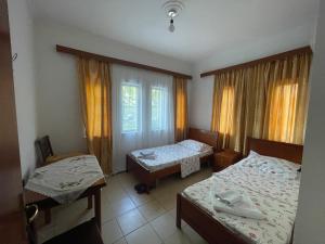 a hotel room with two beds and a window at Bar-Restaurant-Hotel River in Këlcyrë Fshat +6 photos