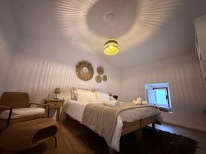 a bedroom with a large bed and a mirror at Casa do Serro de Lá in Santa Clara-a-Nova