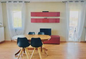 a dining room with a table and four chairs at Orio Relax&Fly in Grassobbio