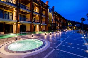 a building with a swimming pool in the middle of a street at Aonang Phu Pi Maan Resort & Spa - SHA Extra Plus in Ao Nang Beach