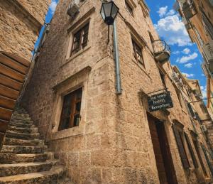 a building with a street sign on the side of it at Old Town Youth Hostel in Kotor