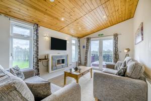 a living room with two couches and a tv at Field View 1 bed-No Pets-Cedar in Eye