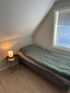 a small bedroom with a bed and a table at Gullvikvegen 33 in Namsos