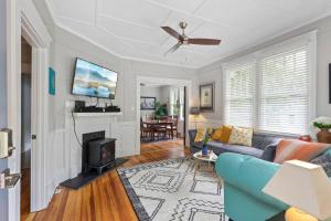 a living room with a couch and a fireplace at Century-Old Remodeled Splendor in Salisbury