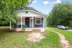 a blue house with a car parked in front of it at Century-Old Remodeled Splendor in Salisbury