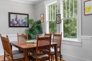 a dining room with a wooden table and chairs at Century-Old Remodeled Splendor in Salisbury
