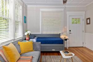 a living room with a bed and a couch at Century-Old Remodeled Splendor in Salisbury