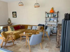 a living room with a couch and a table at La Grange des Loges in Boucé
