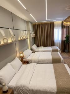 a hotel room with three beds in it at Calm Pyramids View Villa in Cairo