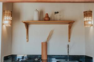a wooden shelf on a wall with a stove at Vila Ronquinha - Arpoador in Tutóia +63 photos