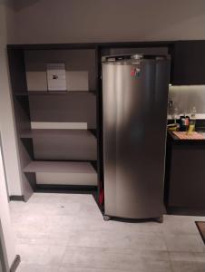 a refrigerator in a kitchen with its door open at FLAT Executivo próx Consulado Americano in Recife